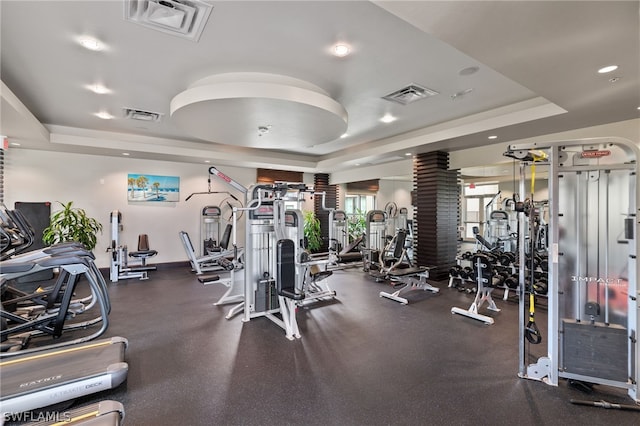 exercise room with a raised ceiling