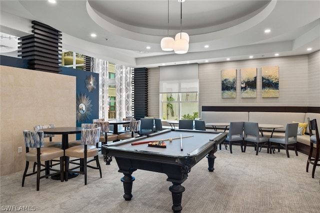 rec room featuring light colored carpet, pool table, and a tray ceiling