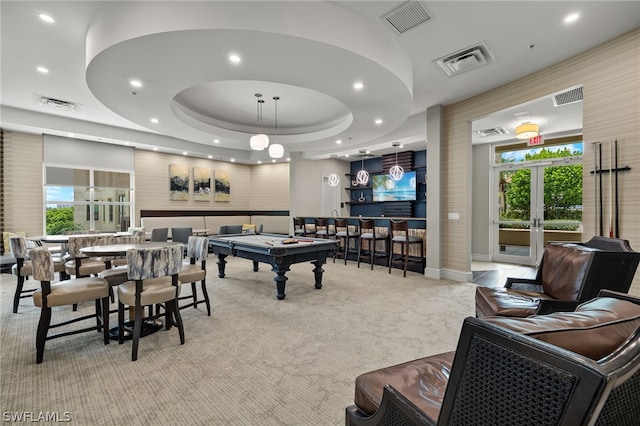 recreation room featuring bar, pool table, a tray ceiling, light carpet, and french doors