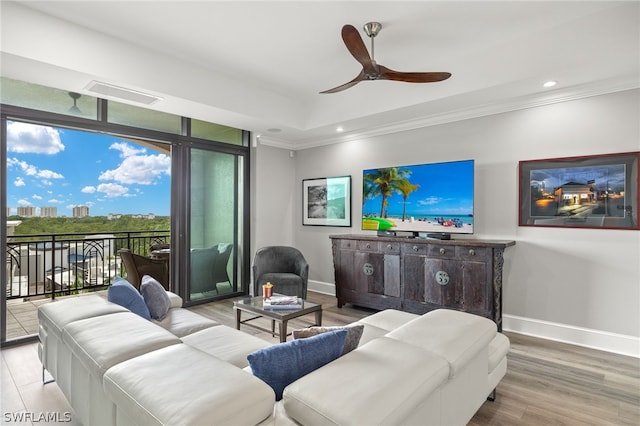 living room featuring ceiling fan, ornamental molding, and hardwood / wood-style floors