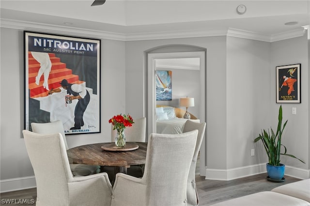 dining area featuring hardwood / wood-style flooring and crown molding