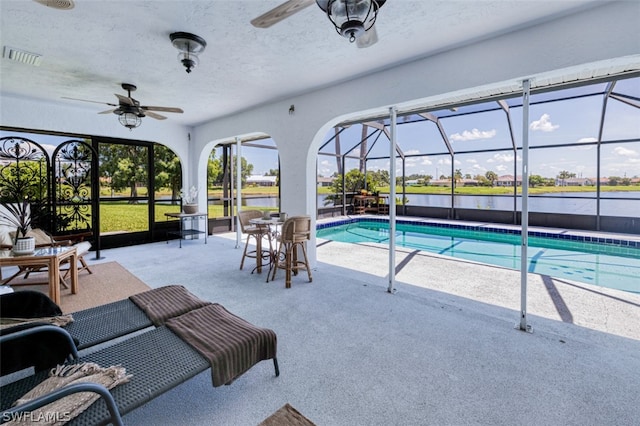 view of pool featuring a lanai, a patio, and ceiling fan