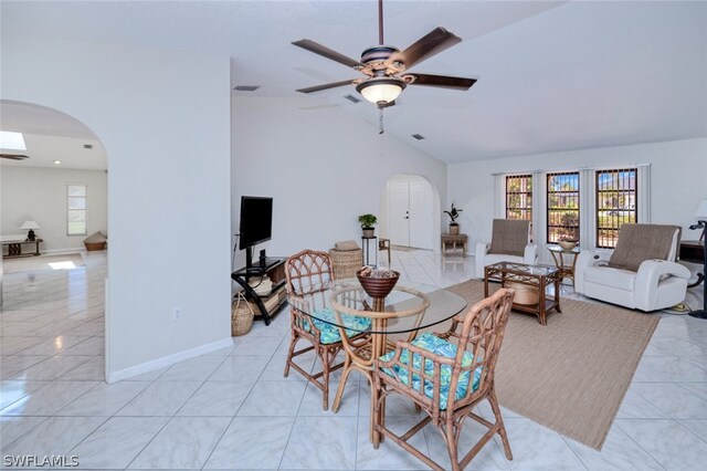 tiled living room featuring lofted ceiling and ceiling fan