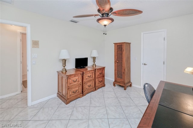 tiled home office featuring ceiling fan