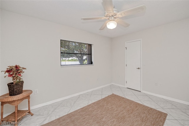 tiled empty room with ceiling fan