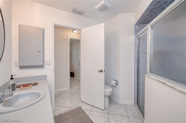 bathroom featuring sink, toilet, and walk in shower