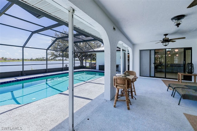 view of pool with a lanai, ceiling fan, and a patio area