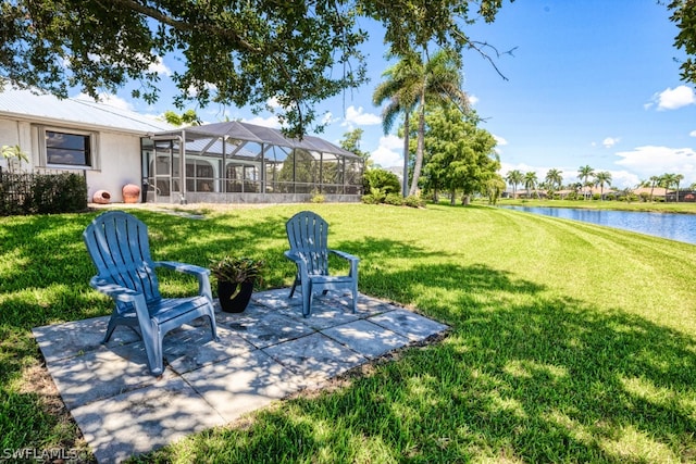 view of yard featuring a patio area, a water view, and a lanai