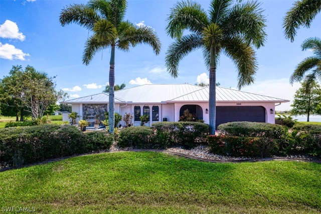 ranch-style home with a garage and a front lawn