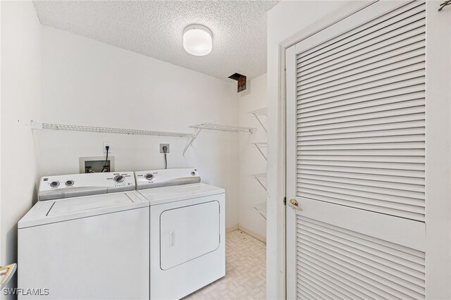 900 Arbor Lake Dr Unit 9-501, Naples, FL 34110 - washroom with washer and dryer, a textured ceiling, and light flooring