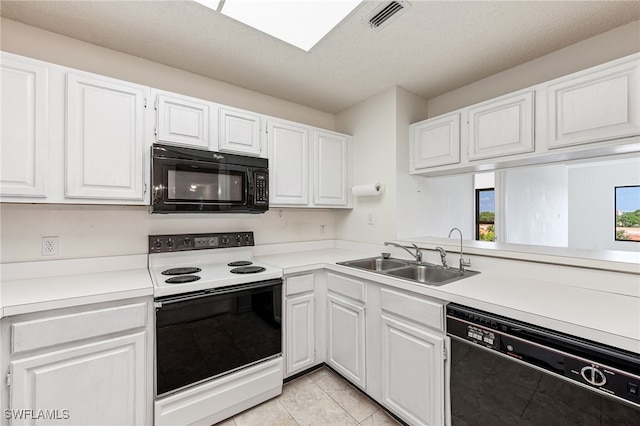 kitchen featuring sink, white cabinetry, and black appliances