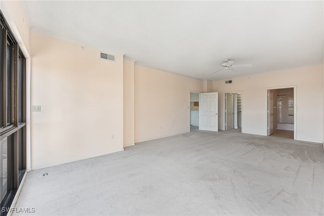 spare room featuring ceiling fan and light colored carpet