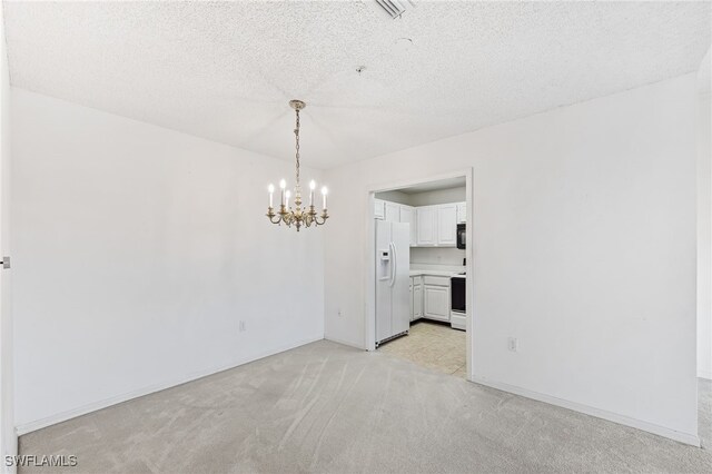 900 Arbor Lake Dr Unit 9-501, Naples, FL 34110 - unfurnished room with a chandelier, light carpet, and a textured ceiling