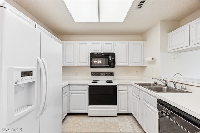 kitchen featuring black appliances, white cabinets, and sink