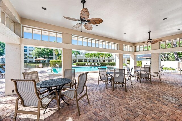 view of patio featuring ceiling fan and a community pool