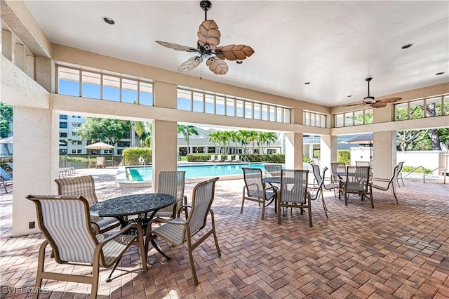 900 Arbor Lake Dr Unit 9-501, Naples, FL 34110 - view of patio featuring ceiling fan, outdoor dining area, a community pool, and fence