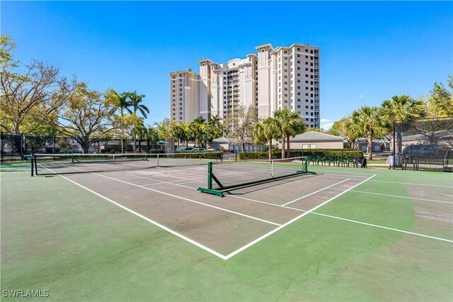 view of tennis court with basketball hoop