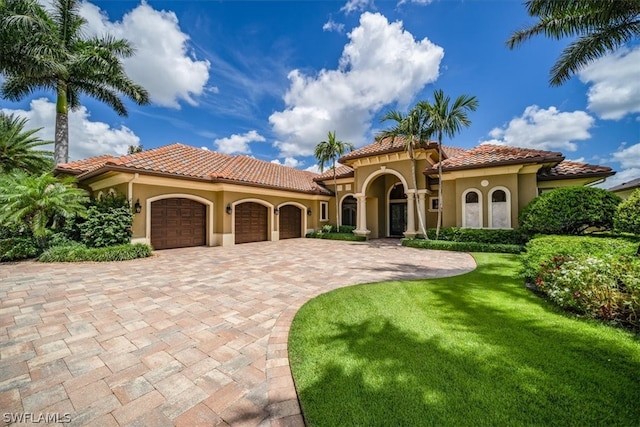 mediterranean / spanish-style home with a front yard