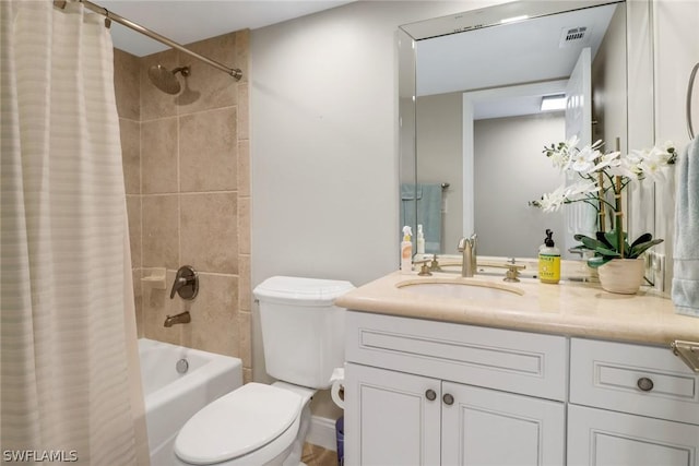 full bathroom with vanity, shower / bath combination with curtain, and toilet