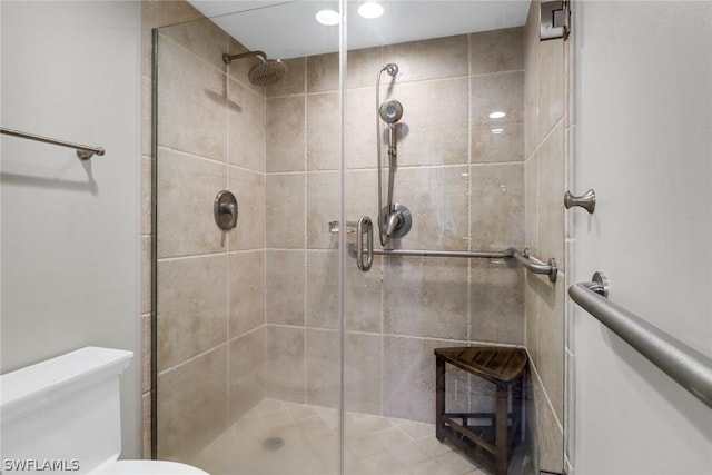 bathroom with toilet and walk in shower