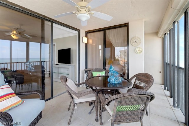 sunroom / solarium featuring ceiling fan