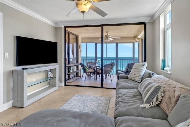 tiled living room with ornamental molding, a water view, and ceiling fan