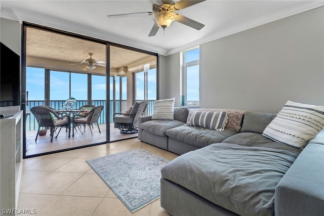 tiled living room featuring crown molding, a water view, and ceiling fan