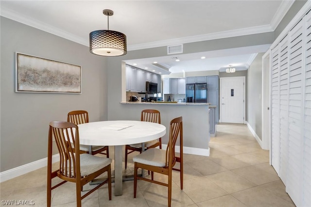 tiled dining room featuring ornamental molding