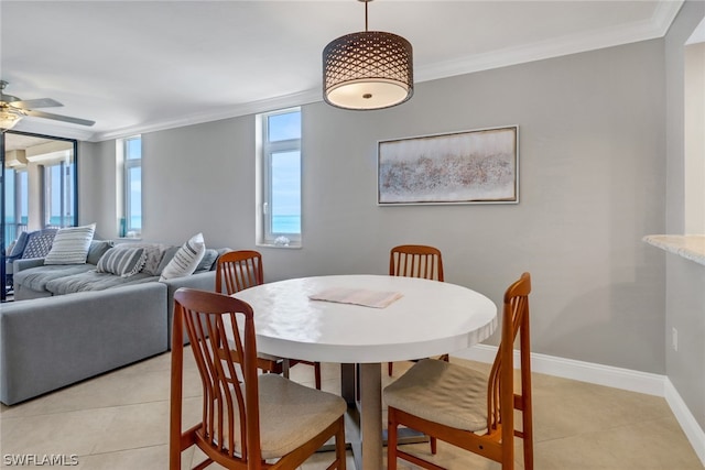 tiled dining area featuring crown molding and ceiling fan