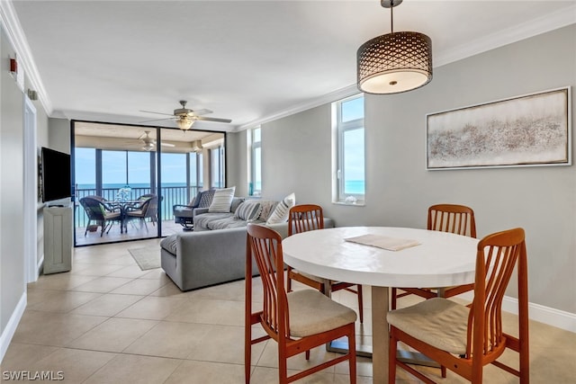 tiled dining area featuring ornamental molding and a wealth of natural light