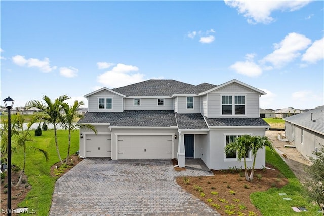 view of front of house with a garage and a front lawn