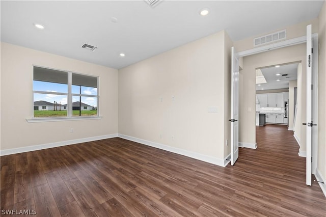 unfurnished room featuring dark wood-type flooring