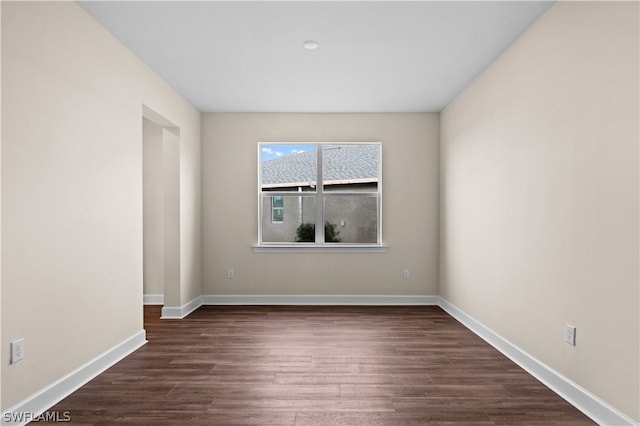 spare room featuring dark hardwood / wood-style flooring