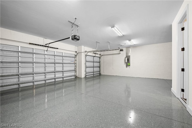 garage featuring a garage door opener and electric panel