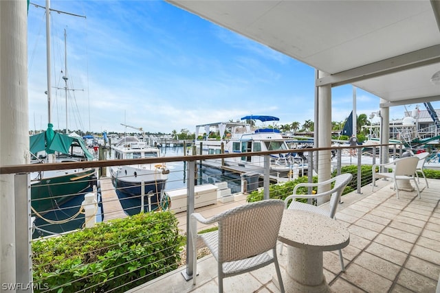 balcony featuring a water view and a dock