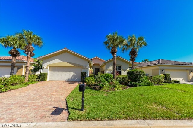 view of front of property featuring a garage and a front lawn