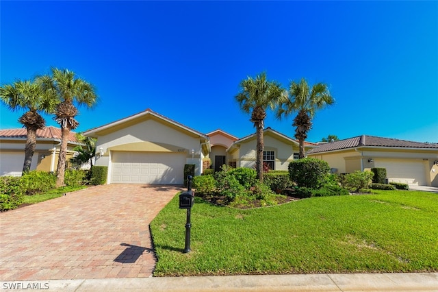 view of front facade with a garage and a front yard