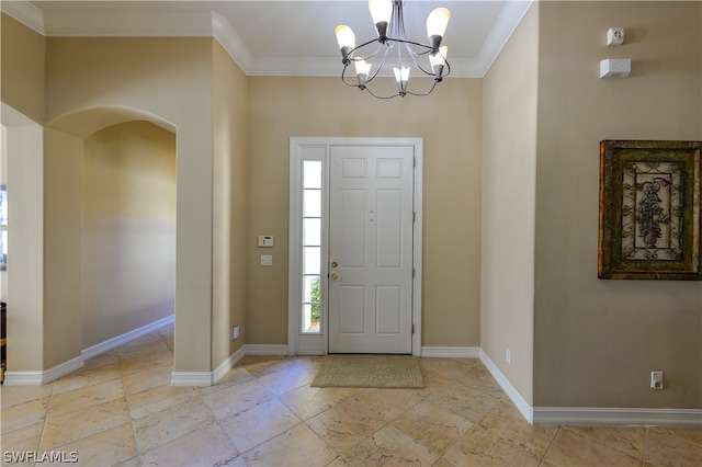 entrance foyer featuring crown molding, light tile patterned floors, and an inviting chandelier