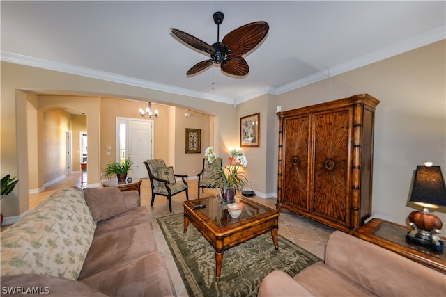 living room with light tile patterned flooring, ceiling fan with notable chandelier, and ornamental molding