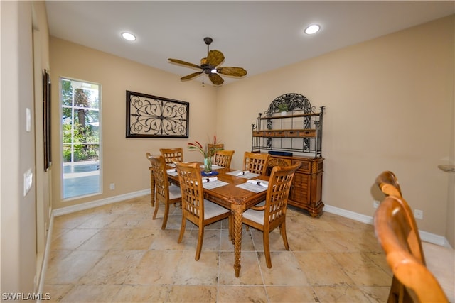 tiled dining area with ceiling fan