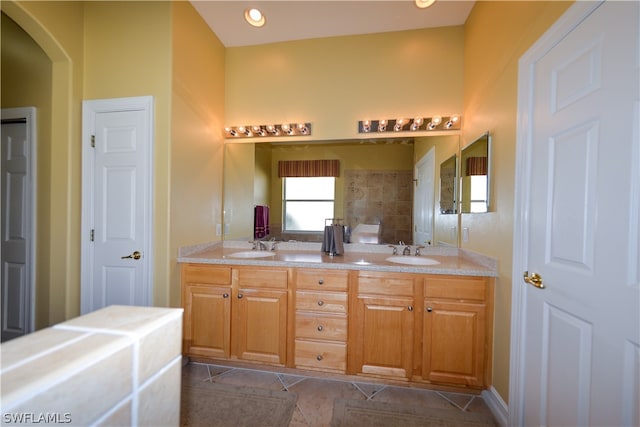 bathroom with tile patterned floors and double sink vanity