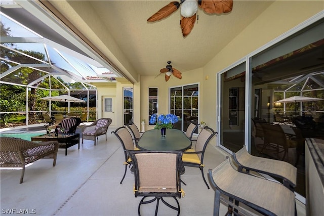 view of patio / terrace featuring a lanai, a swimming pool, and ceiling fan