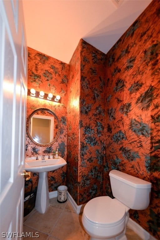 bathroom with toilet and tile patterned floors