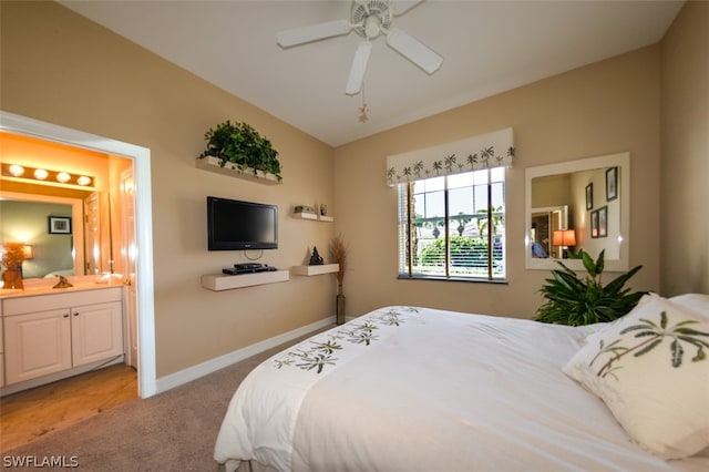 carpeted bedroom with sink, ceiling fan, connected bathroom, and vaulted ceiling