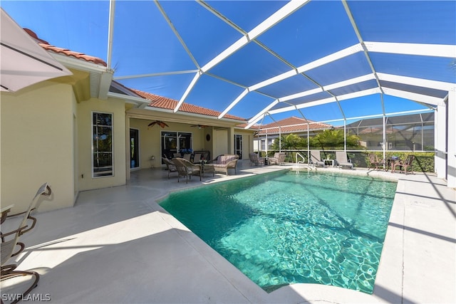 view of swimming pool with a lanai, a patio, an outdoor living space, and ceiling fan