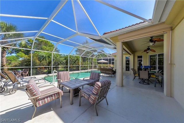 view of patio / terrace featuring ceiling fan and a lanai