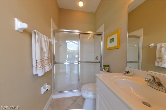 bathroom with tile patterned flooring, a shower with shower door, toilet, and vanity