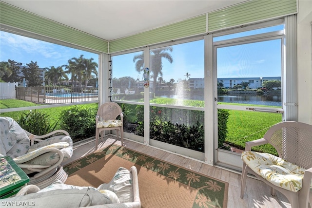 sunroom / solarium with a water view