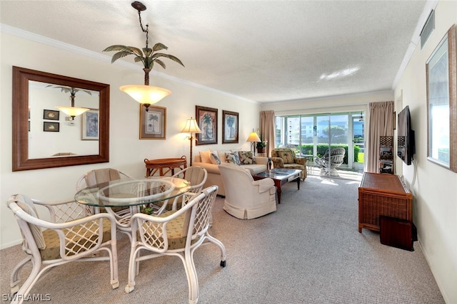 carpeted dining area with crown molding and a textured ceiling