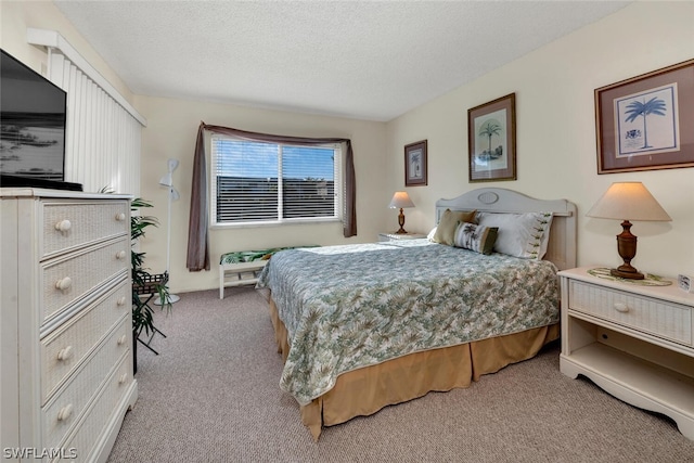 bedroom featuring a textured ceiling and light carpet